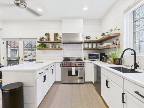Open shelving, warm textures, and modern appliances create a space worth lingering in.