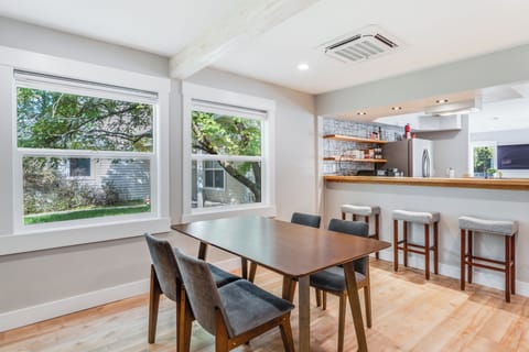 Dining room seating for 4 and bar seating for 3 in this open concept space | Interior