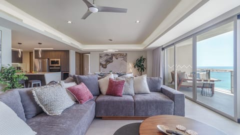 Spacious living room seamlessly connected to the balcony, creating an open indoor-outdoor flow with stunning ocean views