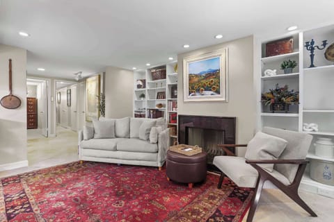 Living room area with a view of doorway to 2 bedrooms