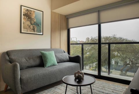 Living area with couch and window view.