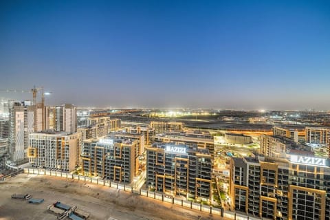 Stunning night view of city skyline with illuminated buildings and roads.