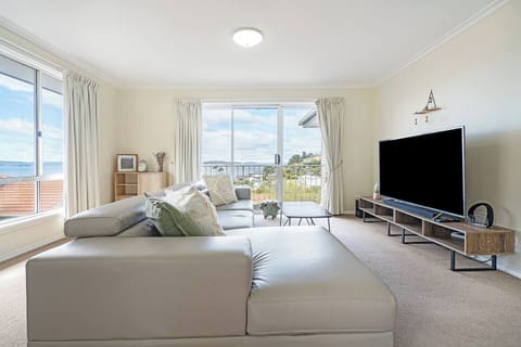 Relax on the plush lounge as sunlight filters through glass doors with glimpses of the river, then unwind in comfort with split-system heating and cooling and a large-screen TV for cosy nights in.