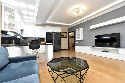Family Apartment, Balcony, Park View | Living area | 50-inch flat-screen TV with cable channels