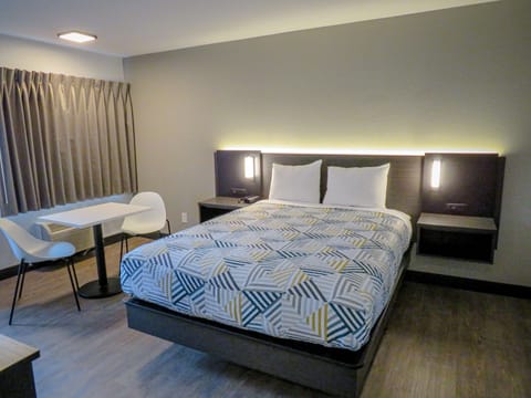 Desk, laptop workspace, blackout drapes, iron/ironing board