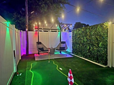 Our backyard oasis truly shines at night! Unwind under the magical glow of string lights and vibrant LED accents after a perfect day.