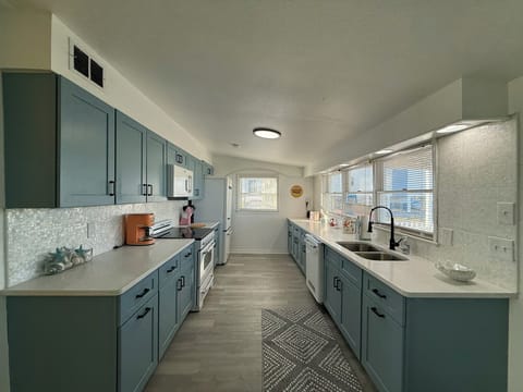 Blue Kitchen Cabinets with Retro Appliances and Mother of Pearl Backsplash!