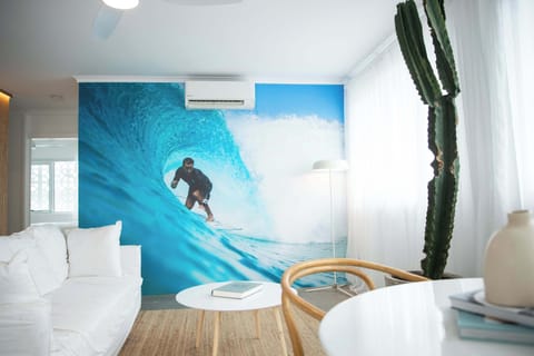 Light-filled living space with custom surf photography and relaxed coastal design