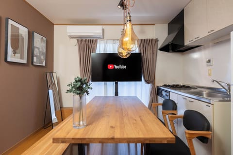 Apartment, Balcony | Living area | 65-inch flat-screen TV with digital channels
