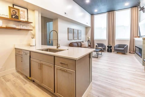 Bright interior design is accented by rays of natural sunlight bursting through the large windows.