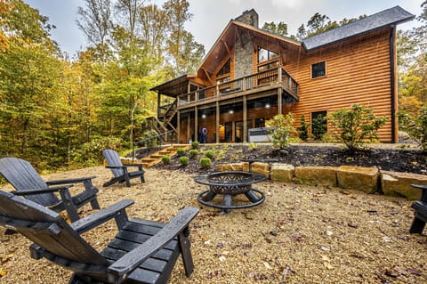 Spacious outdoor fire pit area with cozy Adirondack seating