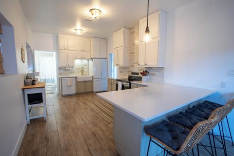 Oven, stove, dishwasher and full-size refrigerator, blender and coffee station.