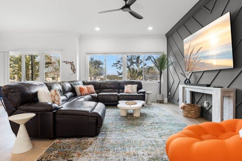 Relax in the reclining leather sectional in front of the massive 85` Smart TV