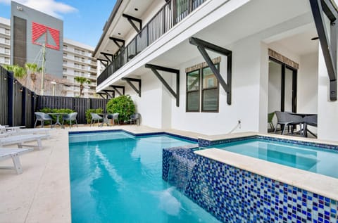 Resort-style backyard oasis with a private HEATED pool, hot tub, spacious pool deck, and a gas grill for outdoor cooking. Lounge seating and dining make this luxury outdoor space perfect for families and large groups. 