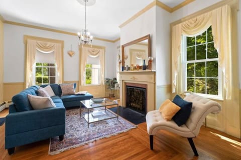 First of three living rooms. This inviting space is filled with an abundance of natural light and cozy furnishings, making it the ideal spot to relax with a good book.  
