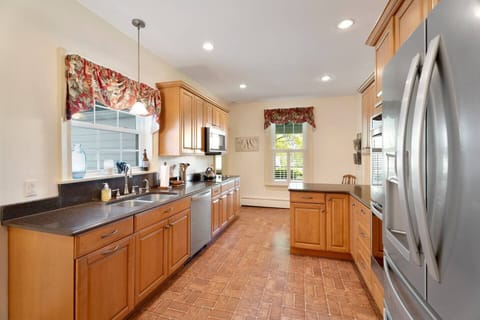 Bright, welcoming and ample in storage and counter space, this kitchen is the heart of the home. Filled with natural light, modern comforts, and plenty of space to cook, gather, and create lasting memories. 
