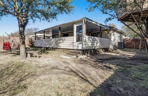 Charming exterior with spacious deck and shaded outdoor areas