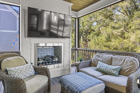 Screened porch with gas fireplace and Smart TV