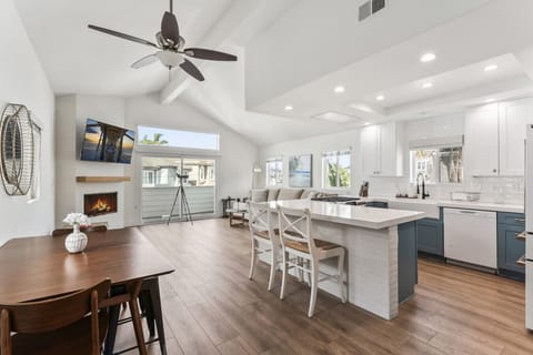 Bright open-concept space w/ kitchen island, dining area & cozy living room for easy gathering