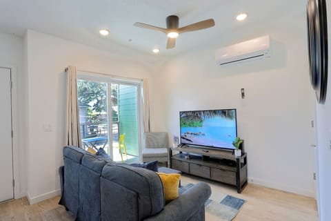 Bright and cozy living space with a TV and access to the private patio for fresh air and sunshine.