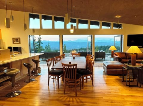 Great room filled with light - floor to ceiling windows and patio French doors