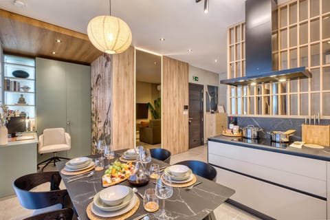 A glimpse of the kitchen, dining, and workspace areas blending together in an open-plan design.