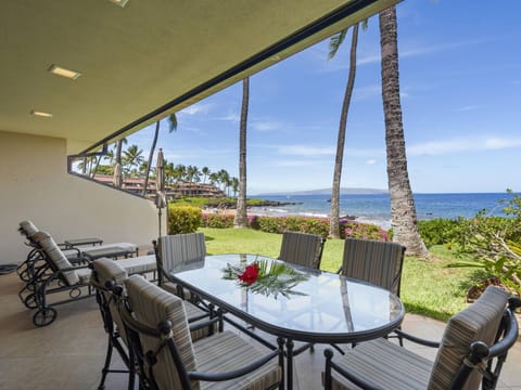 Private Lanai: Enjoy ocean views from your spacious patio featuring two chaise lounges, a dining table, a private Weber grill, and direct access to your beach path.