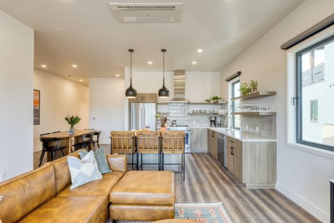 Bright living area with balcony access and smart TV.