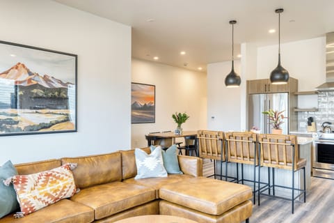 Bright living area with balcony access and smart TV.