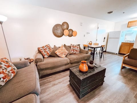 Cozy living room w/ plush seating, warm décor, & plenty of space to unwind.