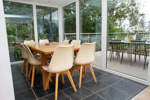Dining area with table and chairs leading to terrace via patio doors