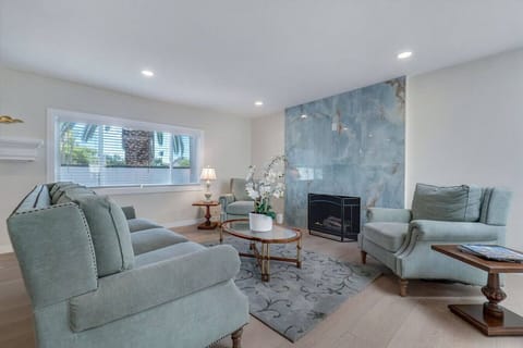 Bright living area with stylish fireplace and seating.