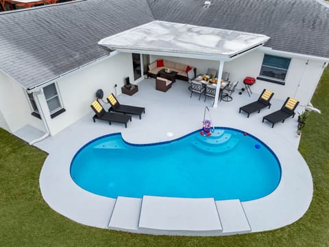 Dine, dip, and dream — this modern outdoor space offers the best of indoor-outdoor living with cozy seating and a refreshing pool.