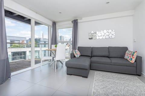 Bright living room with floor-to-ceiling windows and city views