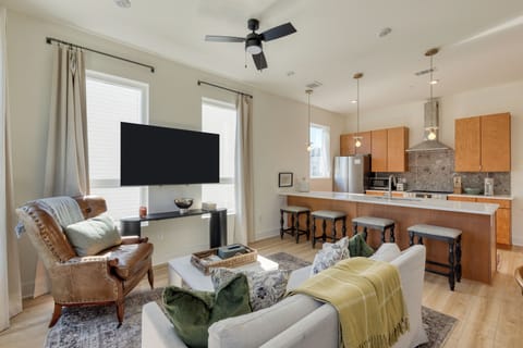 The living room features a large window and a chic modern design.
