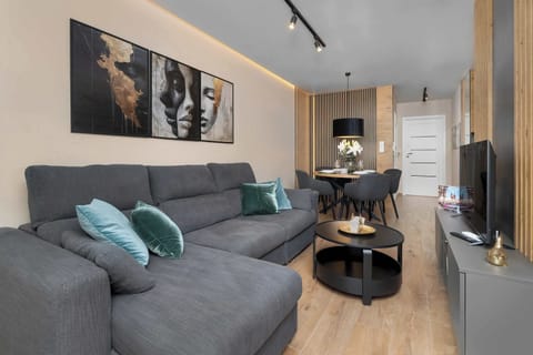 Relax in the stylish living room with a comfortable sofa and modern decor.