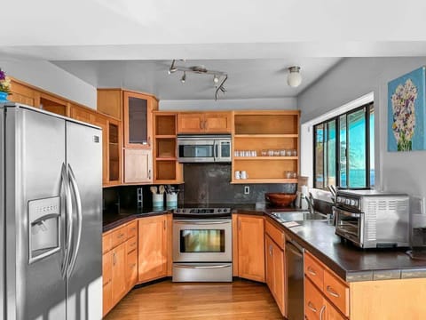 Cozy, well-equipped kitchen with plenty of counter space and natural light. Easy to cook, gather, and enjoy simple meals together