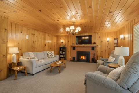 Cozy living room with a flat screen TV and pellet stove.