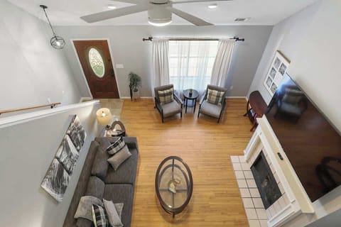An overhead view of the living room from the bedroom highlights the airy, open layout of this charming house. 