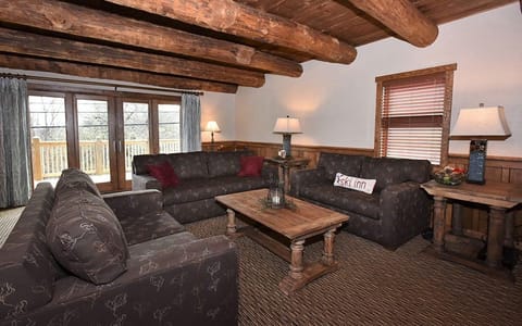 Inviting living area with plush seating and a rustic touch, ideal for enjoying time with family and friends.