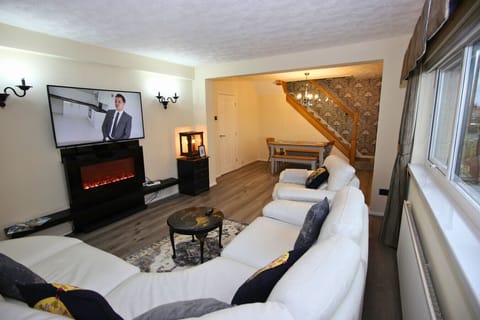 Relax in the spacious living area with modern fireplace and TV