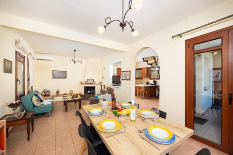 Living room with sofa, dining area, ornamental fireplace, A/C, WiFi internet, and satellite TV