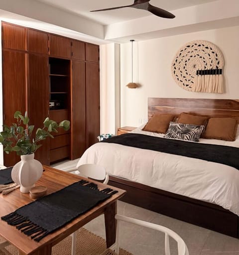 A serene king bedroom blending natural textures, thoughtful design, and boutique-hotel comfort.