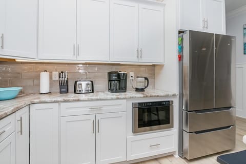 Bright, modern kitchen with stainless steel appliances and ample storage