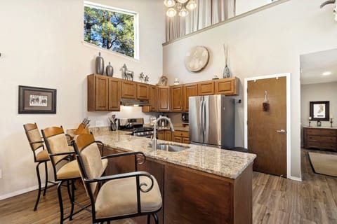 Fully equipped galley kitchen with stainless steel appliances and granite countertops.