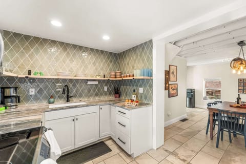 Fully stocked kitchen, with drip coffee maker (complimentary ground coffee, sugar and tea), cookware, dinnerware, and spices. Guests supply their own condiments.