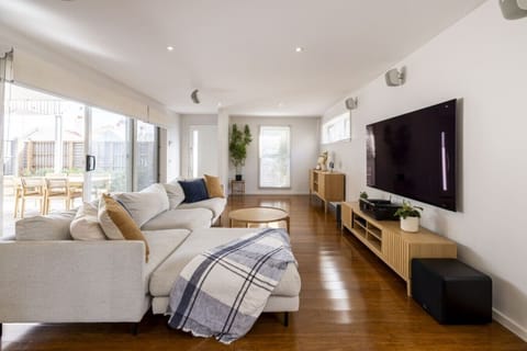 Spacious open-plan living with comfortable seating, Smart TV and seamless indoor-outdoor flow