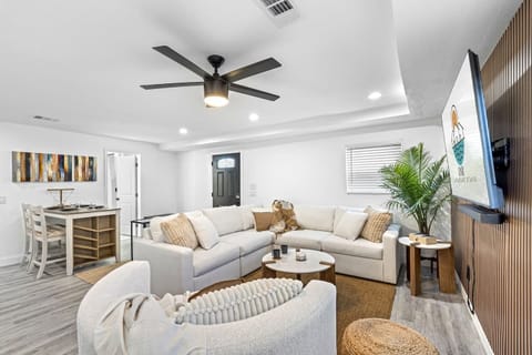 Welcome to our bright and inviting living room featuring a cozy sectional sofa, smart TV, and modern décor.