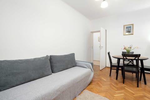 The stylish bedroom includes a comfortable sofa bed and a wardrobe.
