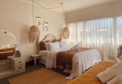 Dream away in the master suite - soft linen, golden light, and a touch of boho charm
